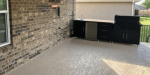 Outdoor kitchen with sink and covered grill.