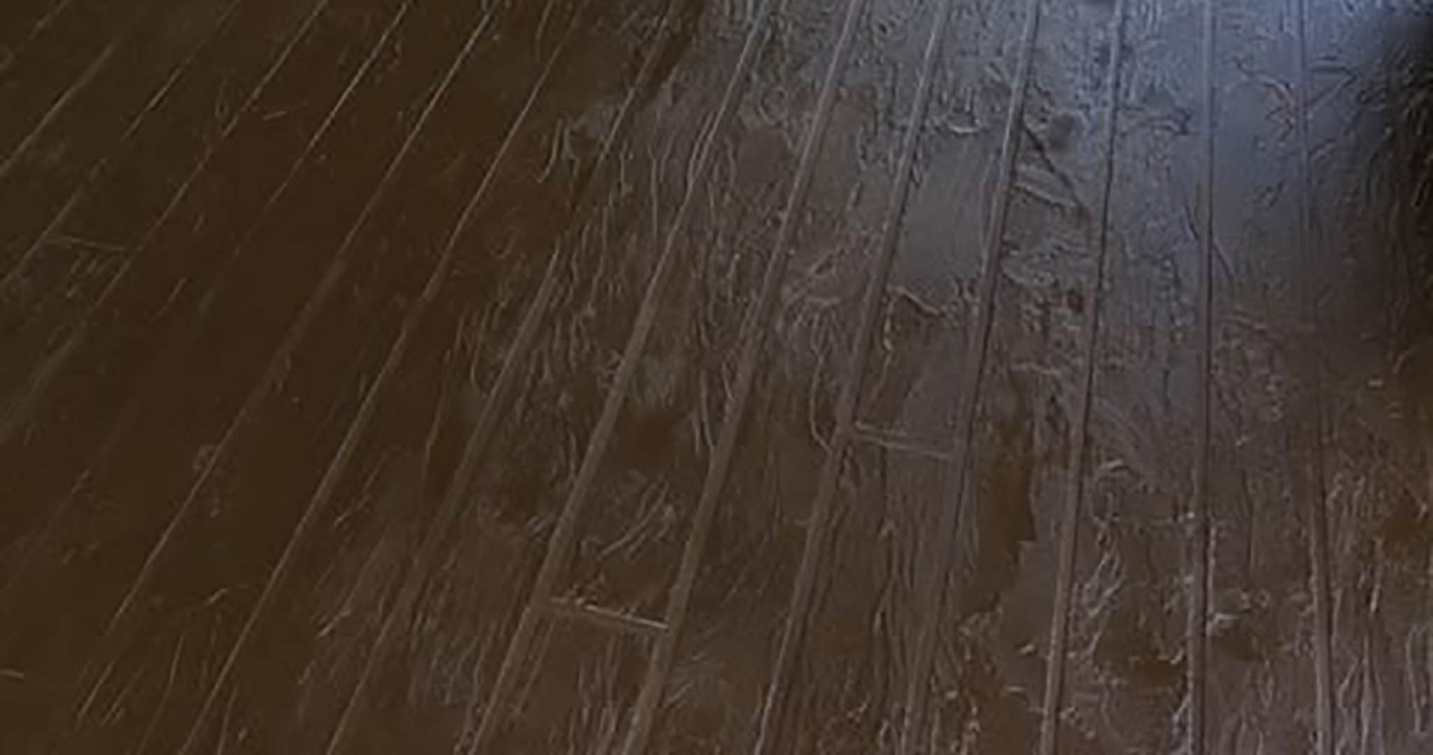 FAUX-WOOD-1 Dark wood flooring with visible texture patterns.
