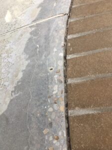 Concrete sidewalk with textured brick border