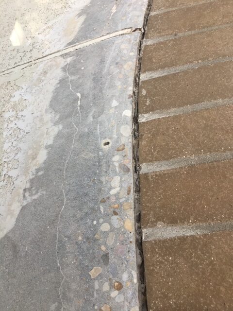 Concrete sidewalk with textured brick border