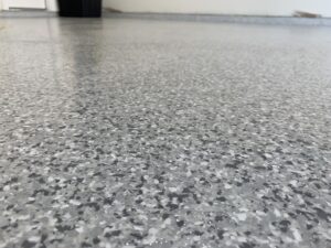 Close-up of speckled gray epoxy floor.