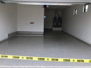 Empty garage with caution tape barrier.
