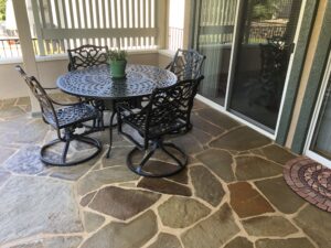 Outdoor patio with table and four chairs.