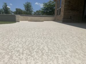 Textured patio with brick wall, sunny day.