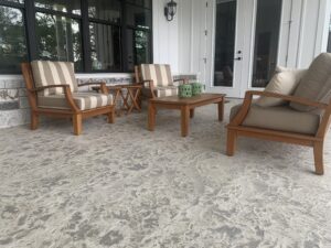 Cozy patio with wooden chairs and table.