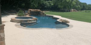 Backyard pool with stone waterfall feature.