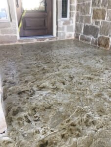 Textured concrete entrance with wooden door
