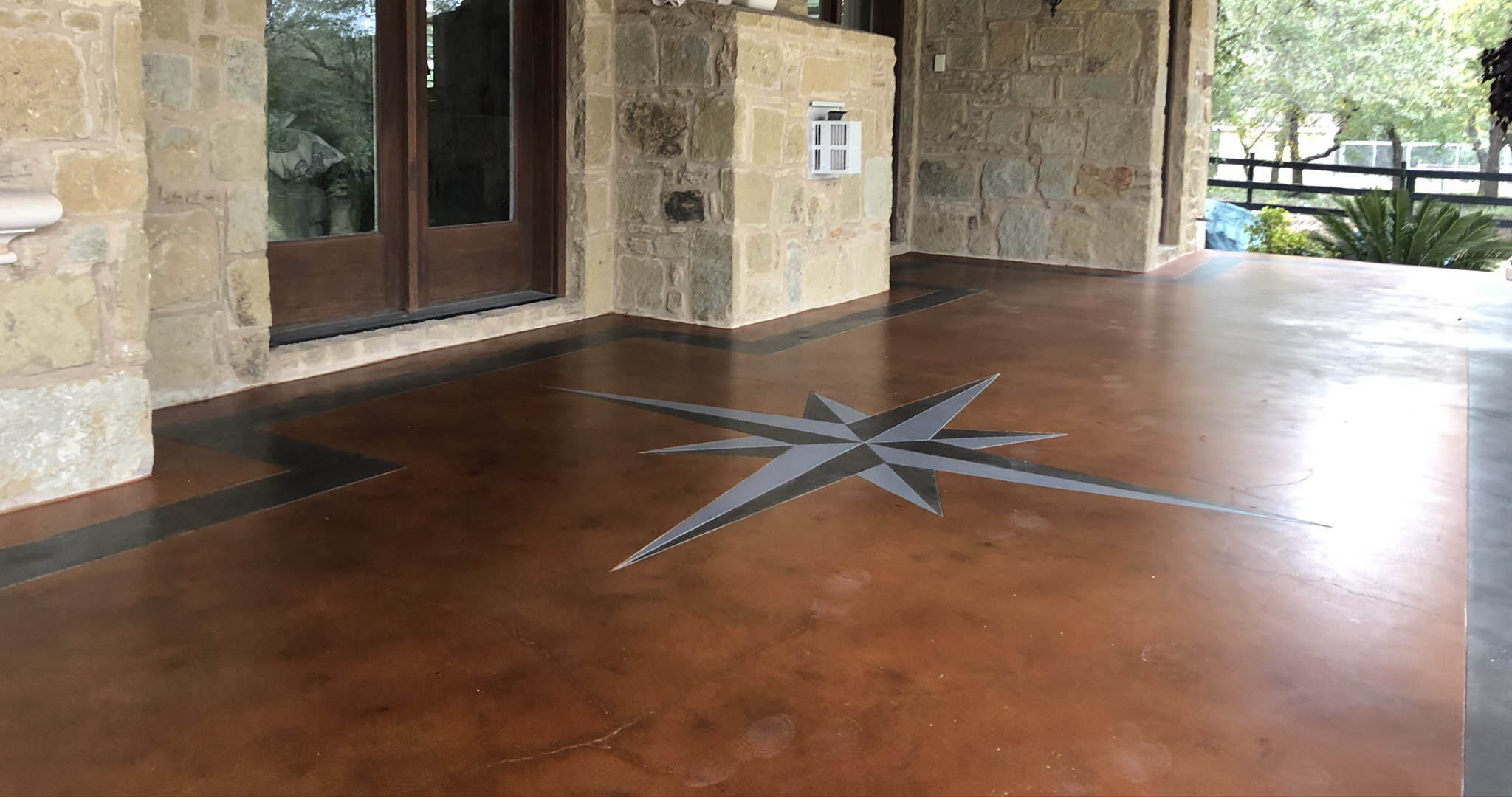 Photo-Nov-19-2-37-15-PM Compass rose design on stone patio floor.