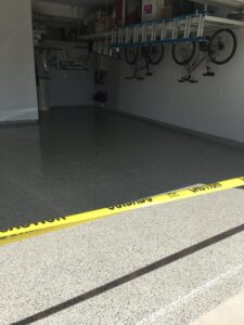 Clean garage with sealed floor and caution tape