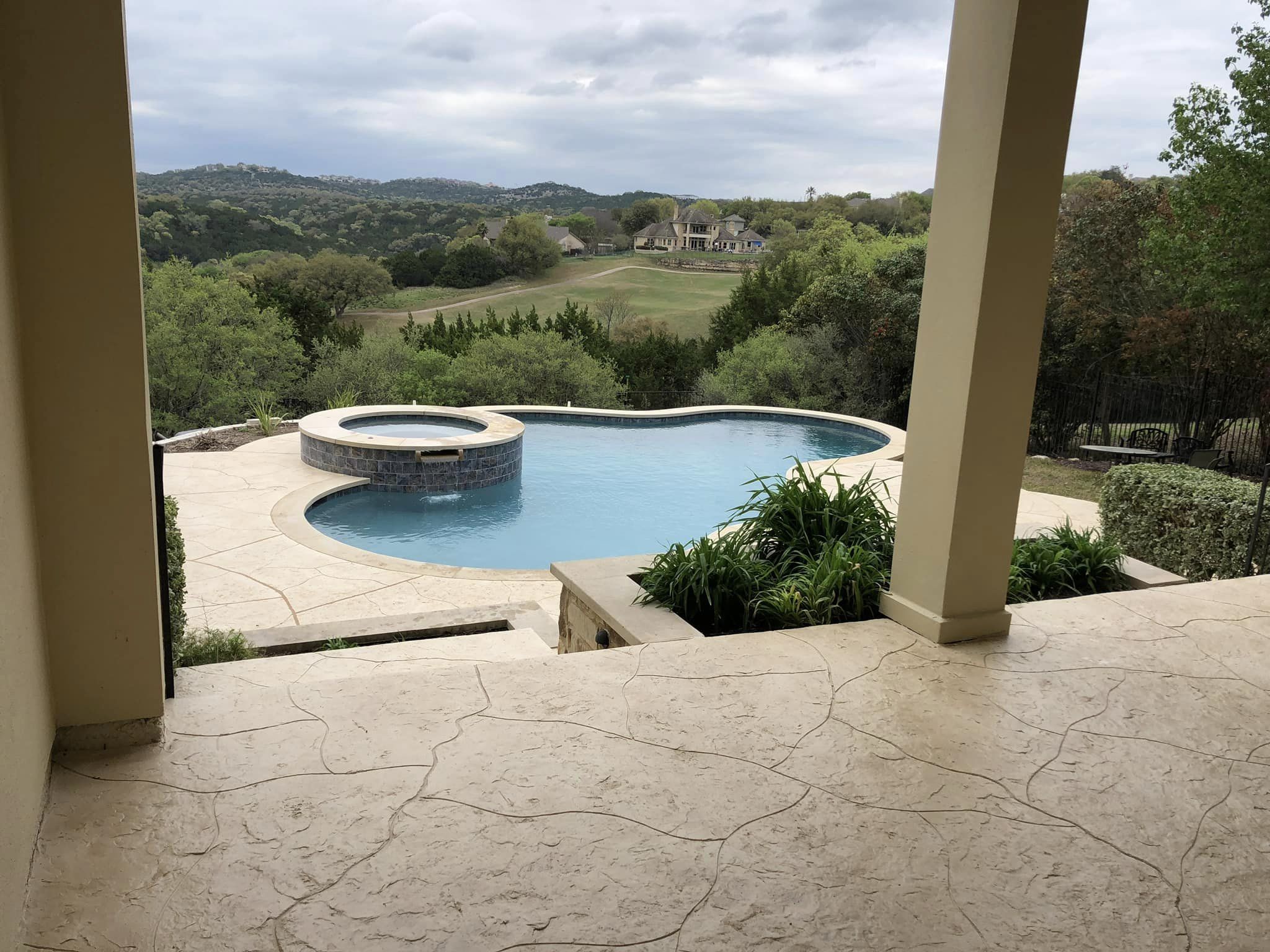 Backyard pool with scenic landscape view.