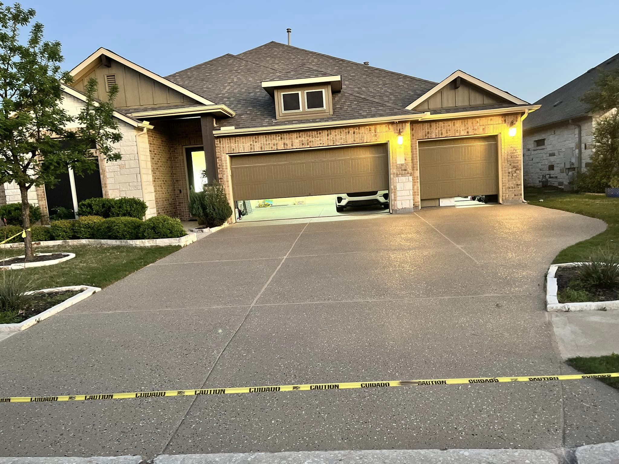 Garage with open doors, caution tape in front.
