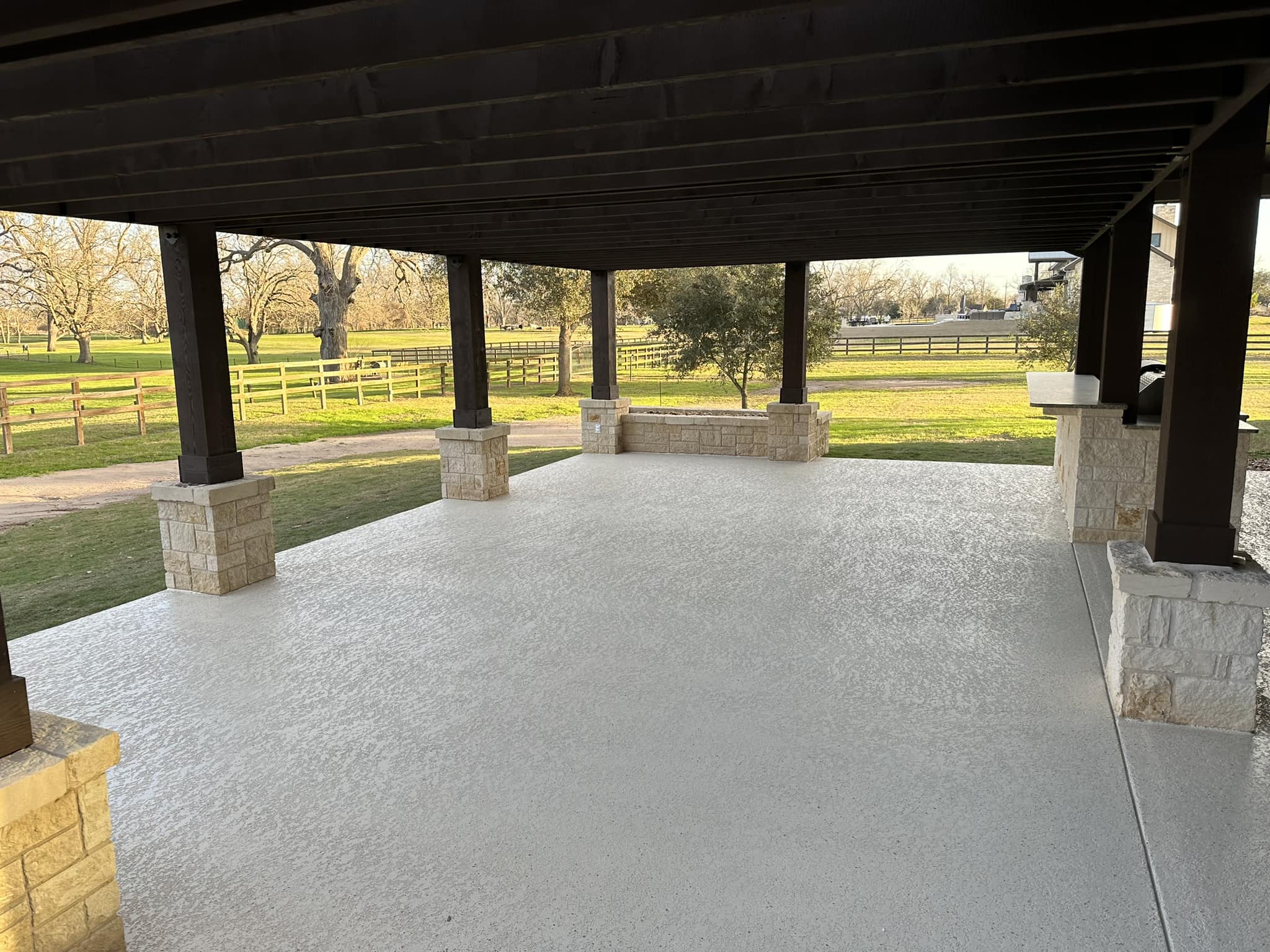 Covered outdoor patio with stone pillars in park