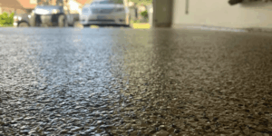 Close-up of epoxy garage floor with parked cars.