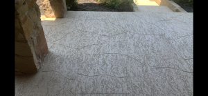 Stone-textured path with light patterns, shaded area.