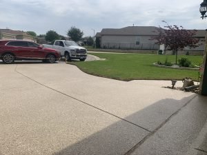 Driveway with parked cars in suburban neighborhood.