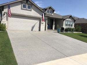 Modern suburban house with flags and driveway