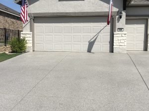 House with American flag and two garage doors.