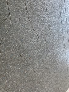 Abstract textured gray wall with curved lines