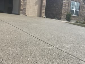 Concrete driveway in front of suburban house.