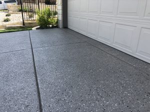 Smooth concrete driveway next to garage door