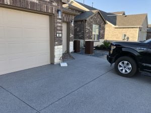 House with garage and black pickup truck.