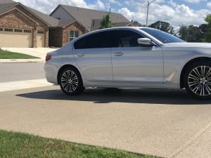 Silver car parked on suburban driveway