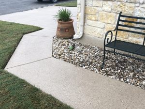 Sidewalk with bench and a decorative planter