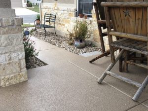 Stone patio with bench and potted plants