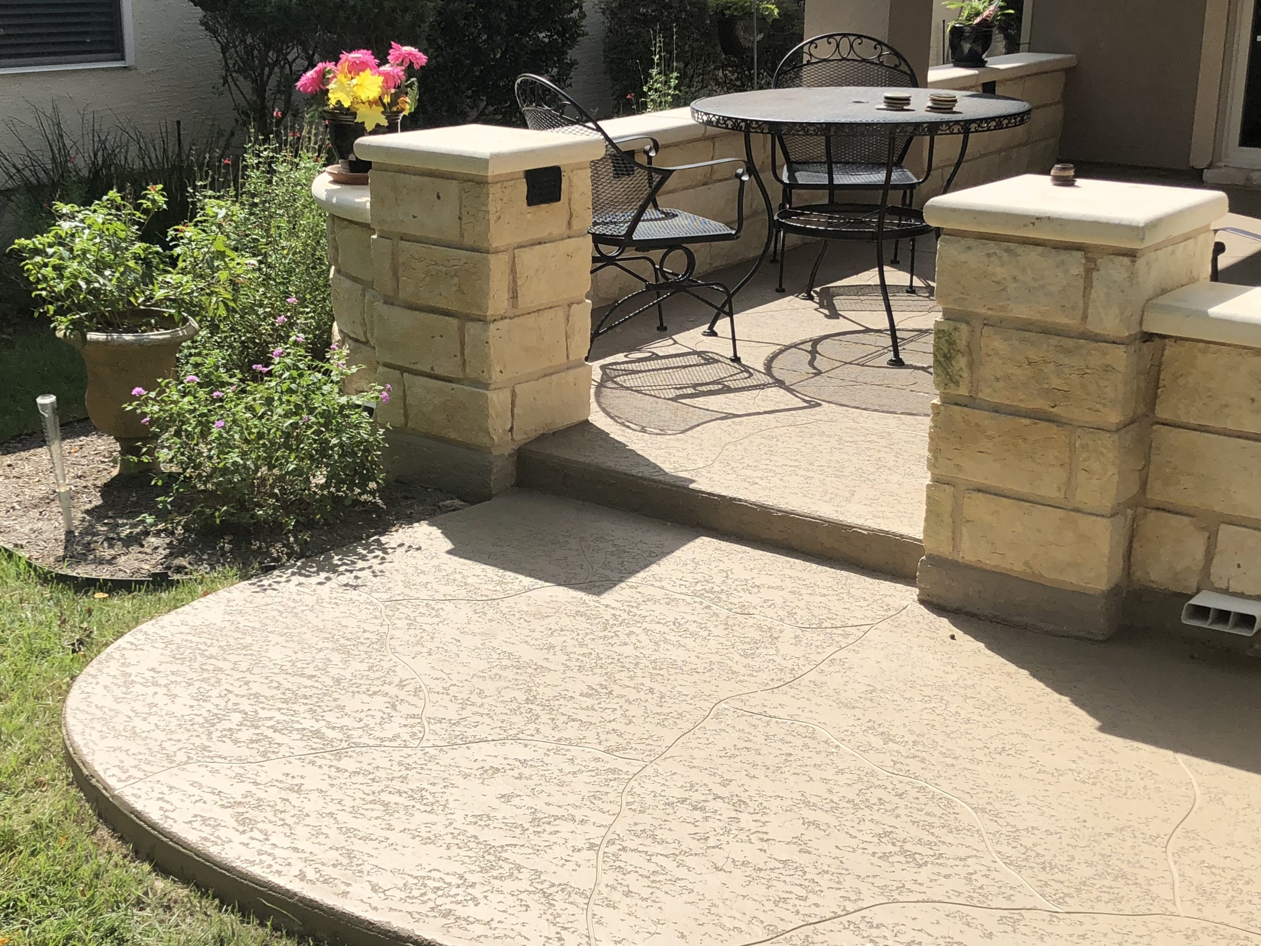 Stone patio with table and flowers