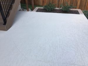 Outdoor concrete patio with plants and stairs