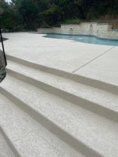 Concrete steps leading to a modern pool area.